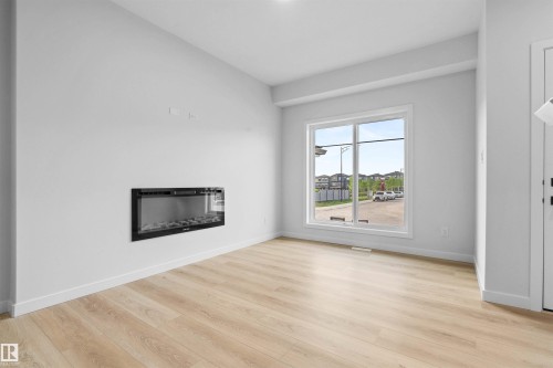 6373 King Wynd, Edmonton, AB - Indoor Photo Showing Living Room With Fireplace