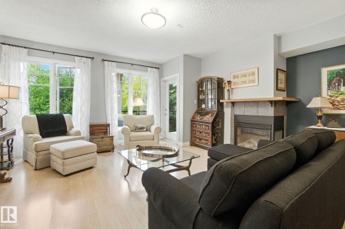 305 9819 96A Street, Edmonton, AB - Indoor Photo Showing Living Room With Fireplace