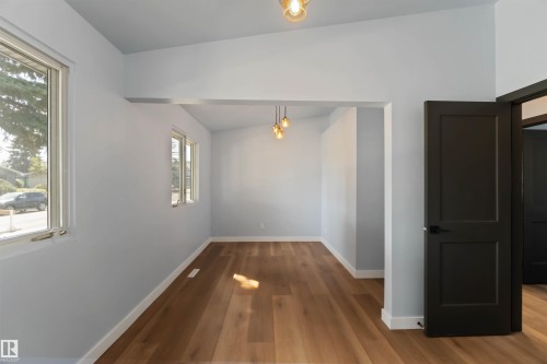 Unfurnished dining area with baseboards and wood finished floors - 6808 95 Avenue, Edmonton, AB - Indoor Photo Showing Other Room