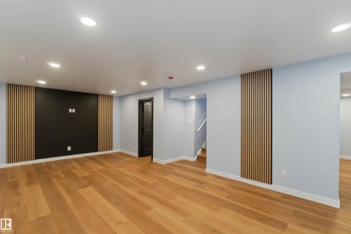 Finished below grade area featuring recessed lighting, light wood-style floors, and stairway - 6808 95 Avenue, Edmonton, AB - Indoor Photo Showing Other Room