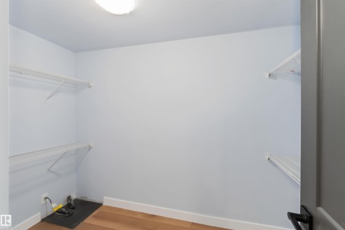 Walk in closet featuring light wood finished floors - 6808 95 Avenue, Edmonton, AB - Indoor With Storage
