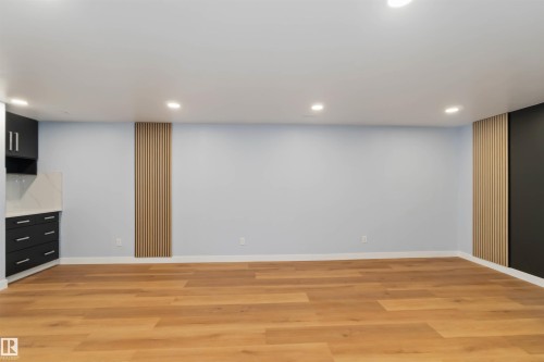 Finished below grade area featuring recessed lighting and light wood-style flooring - 6808 95 Avenue, Edmonton, AB - Indoor