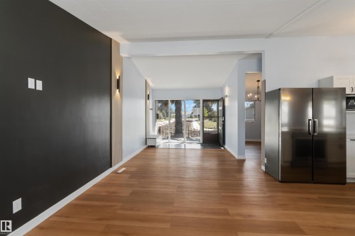 Kitchen with freestanding refrigerator and light wood-type flooring - 6808 95 Avenue, Edmonton, AB - Indoor Photo Showing Other Room