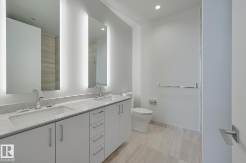 Full bathroom featuring double vanity, recessed lighting, and light tile patterned floors - 4503 10360 102 Nw, Edmonton, AB - Indoor Photo Showing Bathroom