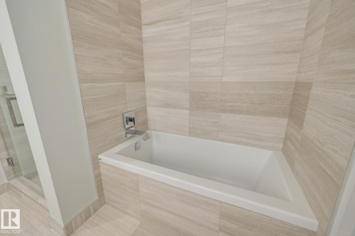 Full bath with a bath, a stall shower, and tile walls - 4503 10360 102 Nw, Edmonton, AB - Indoor Photo Showing Bathroom