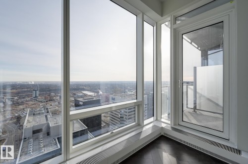 Unfurnished sunroom with a city view and radiator heating unit - 4503 10360 102 Nw, Edmonton, AB - Indoor Photo Showing Other Room