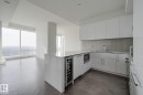 Kitchen with a peninsula, white cabinetry, modern cabinets, beverage cooler, and open floor plan - 4503 10360 102 Nw, Edmonton, AB  - Indoor Photo Showing Kitchen 