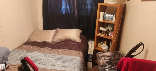 Bedroom with wooden walls - 5002 - 50 Avenue, Dapp, AB - Indoor Photo Showing Bedroom