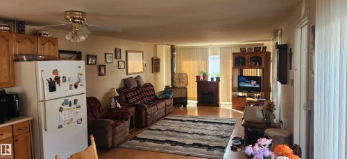Living area with light wood-style floors and ceiling fan - 5002 - 50 Avenue, Dapp, AB - Indoor