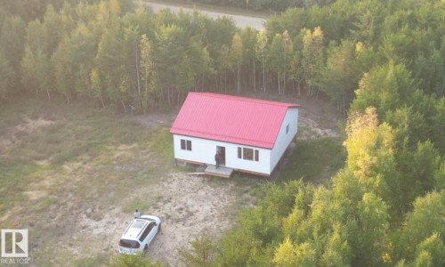 View of subject property with a forest - 4011 50 Avenue, Rural Westlock County, AB 
