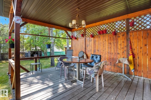 Sunroom with a chandelier - 6309 49 St, Rural Wetaskiwin County, AB - Outdoor With Deck Patio Veranda With Exterior
