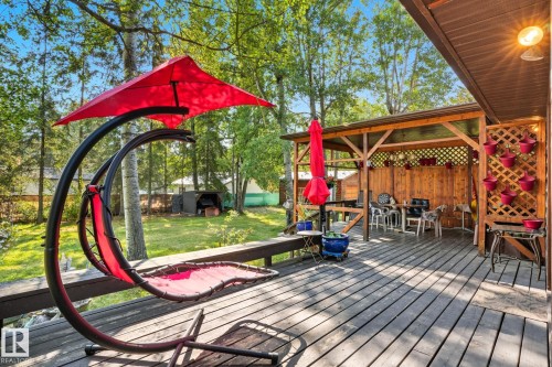 Wooden deck featuring outdoor dining space - 6309 49 St, Rural Wetaskiwin County, AB - Outdoor With Deck Patio Veranda