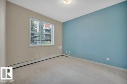 Carpeted spare room with baseboard heating and baseboards - 