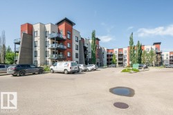 View of apartment building / complex with uncovered parking - 