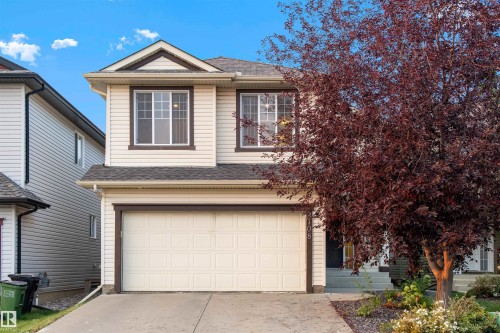 Traditional-style house featuring roof with shingles, concrete driveway, and an attached garage - 2708 Miles Place, Edmonton, AB - Outdoor