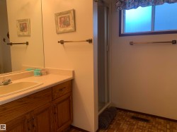 Bathroom featuring vanity and a shower stall - 