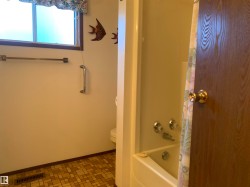 Full bath with shower / tub combo with curtain and baseboards - 