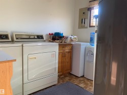 Laundry room with washer and clothes dryer and electric panel - 
