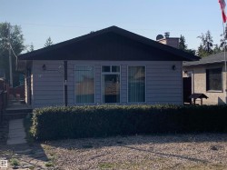 Back of house featuring a chimney - 