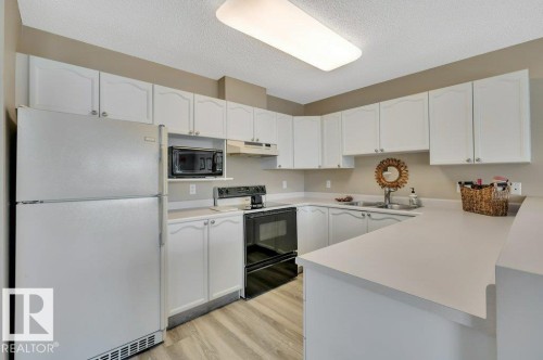 411 65 Gervais Road, St. Albert, AB - Indoor Photo Showing Kitchen With Double Sink
