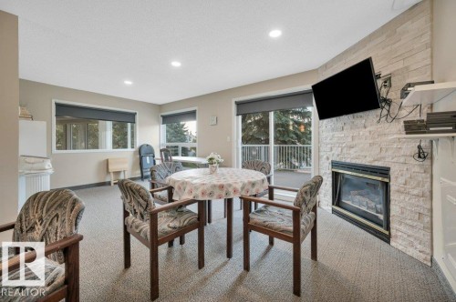 411 65 Gervais Road, St. Albert, AB - Indoor Photo Showing Dining Room With Fireplace