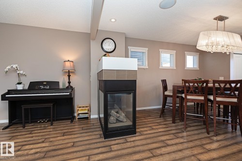 1117 Chappelle Boulevard, Edmonton, AB - Indoor Photo Showing Dining Room With Fireplace