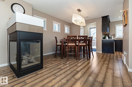1117 Chappelle Boulevard, Edmonton, AB - Indoor Photo Showing Dining Room With Fireplace