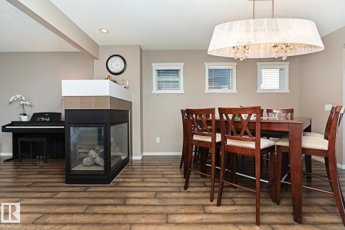 1117 Chappelle Boulevard, Edmonton, AB - Indoor Photo Showing Dining Room With Fireplace