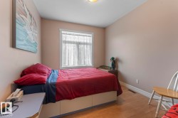 Bedroom featuring wood finished floors and baseboards - 