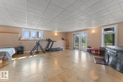 Basement featuring baseboards and a drop ceiling - 