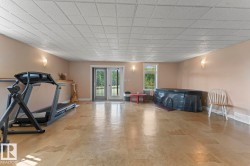 Basement area with baseboards and a drop ceiling - 