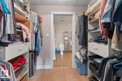 Walk in closet featuring a drop ceiling and light wood-style flooring - 
