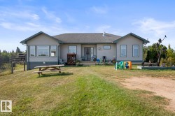 Front view of property with a yard and roof with shingles - 