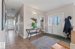 Foyer entrance with tile patterned floors and baseboards - 