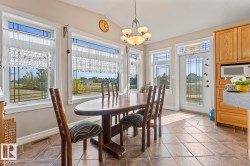 Dining room featuring lofted ceiling, light tile patterned flooring, and a chandelier - 