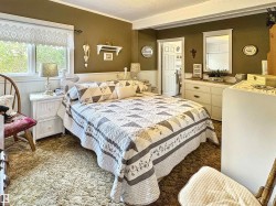 Bedroom featuring carpet, ornamental molding, and a textured ceiling - 