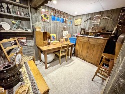 Office with light colored carpet and wood walls - 