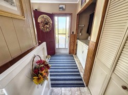 Doorway with washer and clothes dryer and crown molding - 