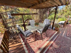 Wooden deck featuring outdoor dining area - 