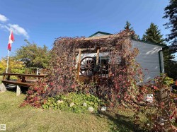 View of home's exterior featuring a wooden deck - 