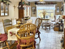 Dining space with a wainscoted wall, plenty of natural light, and crown molding - 