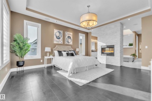 4727 Woolsey Common, Edmonton, AB - Indoor Photo Showing Bedroom With Fireplace