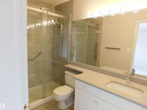 Bathroom featuring vanity, a stall shower, and light tile patterned floors - 26 1295 Carter Crest Road, Edmonton, AB - Indoor Photo Showing Bathroom