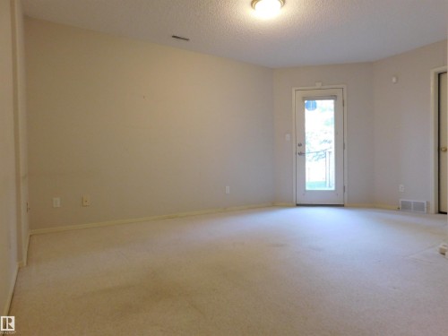 Empty room featuring light carpet and a textured ceiling - 26 1295 Carter Crest Road, Edmonton, AB - Indoor Photo Showing Other Room