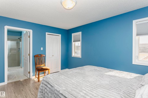 Bedroom with a textured ceiling, wood finished floors, a closet, and ensuite bath - 8 Lafond Drive, Tofield, AB - Indoor Photo Showing Bedroom