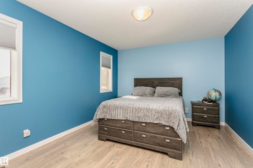Bedroom featuring a textured ceiling and wood finished floors - 8 Lafond Drive, Tofield, AB - Indoor Photo Showing Bedroom