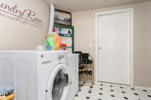 Laundry room featuring separate washer and dryer and light flooring - 8 Lafond Drive, Tofield, AB - Indoor Photo Showing Laundry Room
