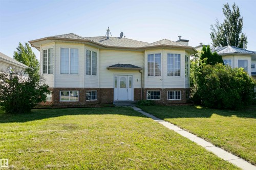 Bi-level home with brick siding, a front lawn, and roof with shingles - 8 Lafond Drive, Tofield, AB - Outdoor With Facade