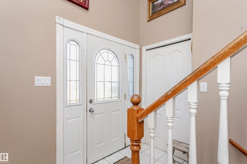 Foyer entrance featuring light tile patterned flooring and stairway - 8 Lafond Drive, Tofield, AB - Indoor Photo Showing Other Room