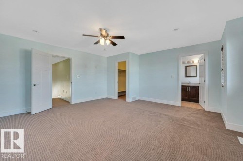 Unfurnished bedroom featuring light colored carpet, a spacious closet, and a ceiling fan - 6221 167A Avenue, Edmonton, AB - Indoor Photo Showing Other Room